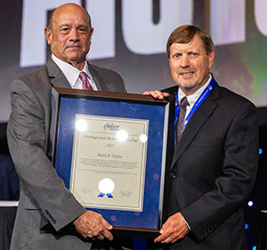 Tom Toner (left) presented the Distinguished Member and Fellow Award to Keith A. Taylor (right).