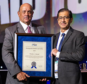 Tom Toner (left) presented the Distinguished Member and Fellow Award to Pinakin C. Chaubal (right).